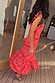 Red Bandana Remi Dress featuring leopard print frill sleeves and an asymmetrical hem on a sunlit wooden deck.