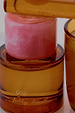 NFD Eau De Parfum 002 in an amber glass bottle with a marbled pink cap and gold script branding.