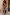 Thumbnail for Banana Dorris Skirt in a multicoloured hand-painted banana print on black jersey, styled as a co-ord against a stone wall.