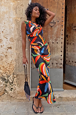 Banana A-Symmetric Top and matching skirt co-ord with vibrant banana motifs on a model against a stone wall.