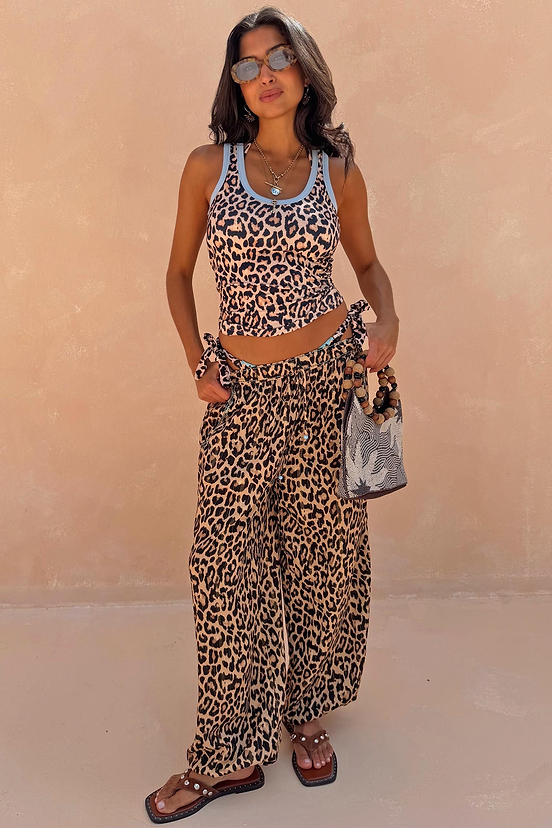 Leopard Balloon Trouser and matching leopard tank top styled with a beaded bag for a vacation look.
