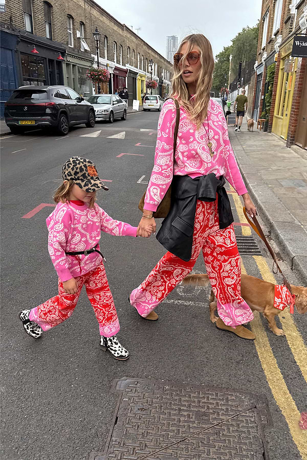 Kids Red and Pink Bandana Knitted Set on a child walking with a model and a dog on a London street.