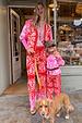 Kids Red and Pink Bandana Knitted Set on a girl and woman standing outside a London shop with a dog.