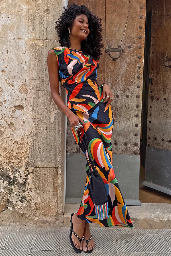 Banana A-Symmetric Top and matching skirt with vibrant multicoloured banana motifs on a black jersey base.