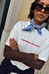Blue Cotton Stripe Bandana tied around the neck, styled with a white graphic t-shirt and studded sunglasses.