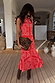 Red Bandana Remi Dress featuring leopard print sleeves and an asymmetrical frill hem, styled with a leopard clutch.