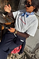 Blue Cotton Stripe Bandana in blue and red, tied at the neck and paired with a graphic tee for a London street style look.