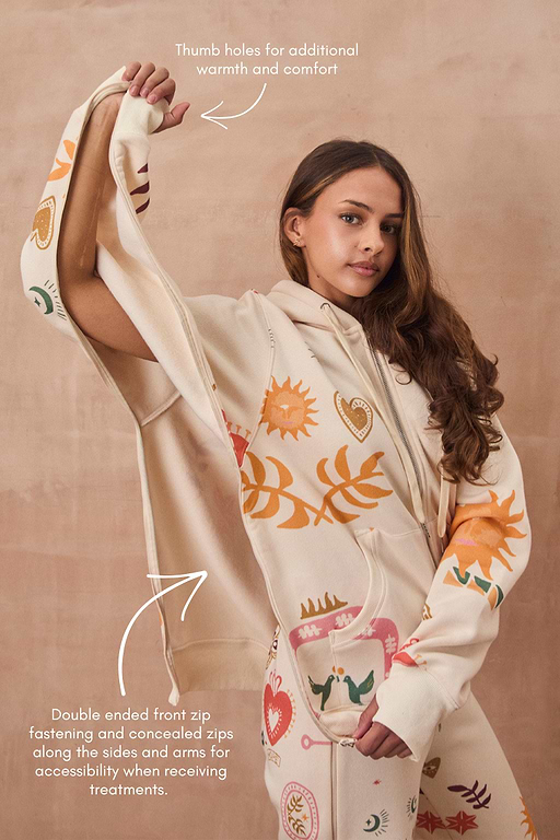 Cream Sundazed Accessible Hoodie featuring sun prints, concealed zips for treatment access, and thumb holes.