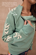 Sage Sundazed Accessible Sweatshirt with cream palm print and a concealed chest zip for treatment access.