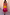 Thumbnail for Petite Tiered Orange and Pink Abigail Dress featuring a sheer bodice and floaty skirt in bold summer tones.