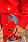 Red Celestial Cardigan detail with embroidered blue hand, yellow stars, and LOVE motif on a soft red knit base.
