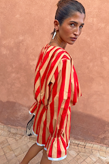 Tomato Stripe Blouse in red and camel striped cotton with voluminous sleeves and flared cuffs on a model.