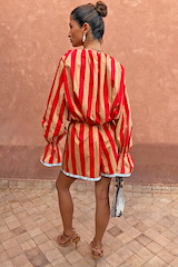 Tomato Stripe Ellie Shorts and matching blouse co-ord in red and camel worn by a model from behind.