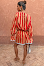 Tomato Stripe Ellie Shorts and matching blouse co-ord in red and camel worn by a model from behind.