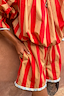 Thumbnail for Tomato Stripe Ellie Shorts featuring red and camel stripes with a blue contrast frill hem and pockets.