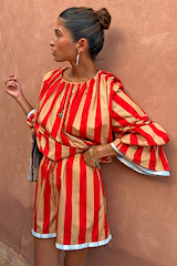 Tomato Stripe Ellie Shorts and blouse co-ord in red and camel stripes with a blue contrast trim.