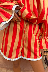 Tomato Stripe Ellie Shorts featuring red and camel stripes, a drawstring waist and blue frill hem.