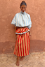 Thumbnail for Tomato Stripe multi-wear dress styled as a red and camel maxi skirt with a blue striped high-neck scarf top.