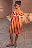 Tomato Stripe Mini Dress in red and camel stripes with a ruffled off-the-shoulder neckline.