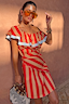 Tomato Stripe Mini Dress in red and camel stripes with ruffle detailing, blue trim and orange sunglasses.