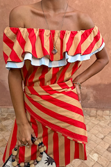 Tomato Stripe Scarf in red and tan, styled as a multi-wear waist wrap over a matching off-the-shoulder dress.