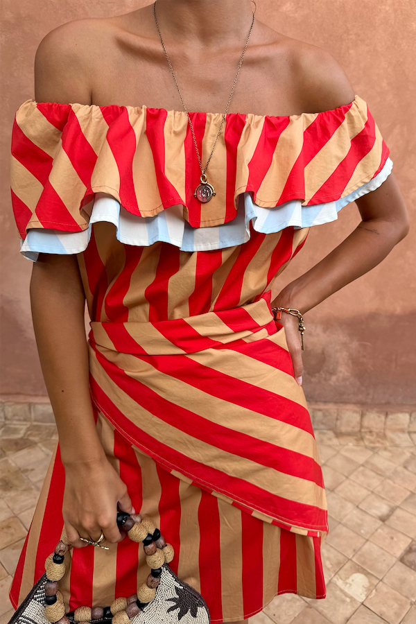 Tomato Stripe Scarf in red and tan, styled as a multi-wear waist wrap over a matching off-the-shoulder dress.
