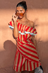 Multi-wear Tomato Stripe Scarf in red and tan, styled as a ruffled off-the-shoulder dress on a model.