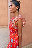 Tomato Tapestry Frida Dress in red featuring sun motifs and contrasting spot print ruffle sleeves.