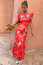 Thumbnail for Tomato Tapestry Frida midi dress in red featuring sun motifs and ruffle sleeves, styled with gold mules.