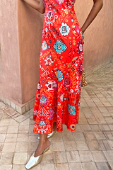 Red Tomato Tapestry Frida Dress featuring a sun motif patchwork print and fluted hem, styled with gold mules.