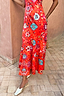 Red Tomato Tapestry Frida Dress featuring a sun motif patchwork print and fluted hem, styled with gold mules.
