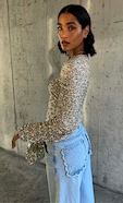 model wears our silver sequin tia top with our blue scallop jeans