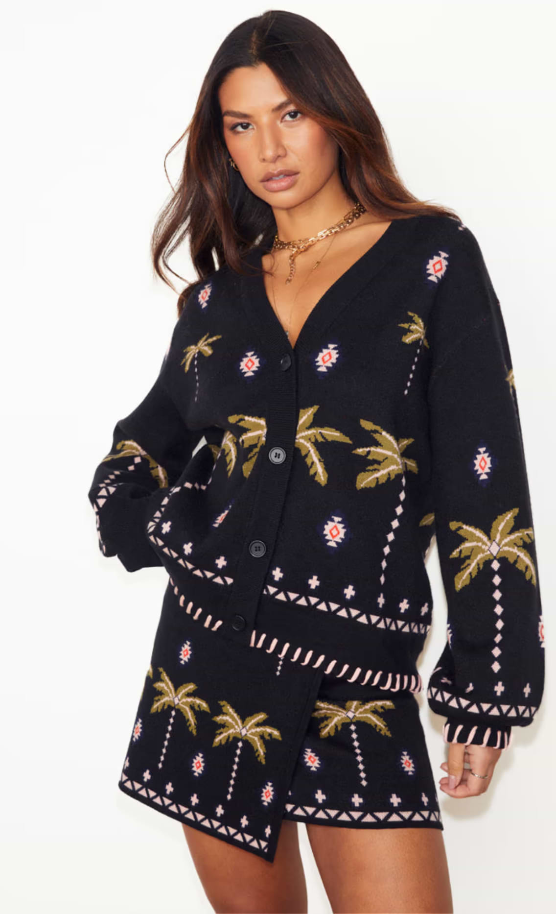 model is wearing palm leaf design cardigan with matching mini wrap skirt 