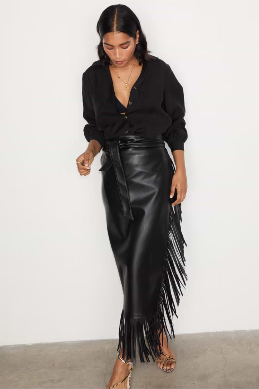 close up of our black vegan leather jaspre wrap skirt with fringe detailing 