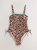 Leopard bandeau swimsuit with blue whipstitch embroidery and ruched side ties, shown in a flat lay.