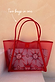 Red Mesh Tote Bag with leather straps and a detachable sun face print pouch, highlighting the two-in-one design.