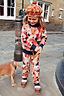 NFD Kids Aspen geometric knit jumper and joggers set on a young girl walking a dog along a London street.