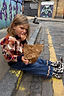 Thumbnail for NFD Kids Aspen Jumper with a geometric knit pattern, worn with jeans and cow-print boots on a cobbled London street.