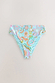Blue Dreamer High Waist Brief featuring a vibrant sun and palm abstract print on a light blue base.