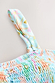 Blue Dreamer Shirred Bandeau Top detail featuring light blue shirred fabric and an adjustable strap with sun motifs.