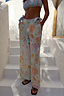 Blue Dreamer beach trousers with a sun and star print, featuring an elasticated tassel waistband and side pockets.