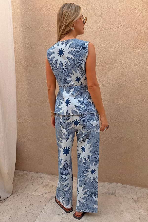 Soleil Jeans in blue denim with oversized sun motifs, styled with the matching waistcoat as a co-ord set.