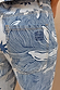 Soleil Jeans back pocket detail featuring a blue and white wavy line print and embroidered sun motif.