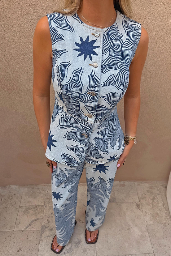 Sleeveless Soleil Denim Waistcoat featuring a blue sun motif print and button front, styled as a co-ord.