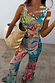 Blue Mari Plisse Trousers and matching top in a vibrant paisley print, styled with a natural woven bag.