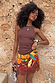 Chocolate Ribbed Tank in soft stretch fabric, styled with a vibrant fruit print lace skirt for a summer vacation look.