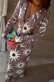Chocolate Soleil Alexa Cardigan and Dorris Skirt co-ord featuring a brown sun motif print and beaded clutch bag.