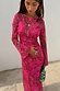 Pink Paisley Mesh Dress with long sleeves and a sheer paisley print, styled with gold jewellery and a beaded bag.
