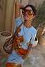 Thumbnail for Ice Blue Floral Rib Dress with a bold orange floral print and ribbed texture, styled with oversized sunglasses.