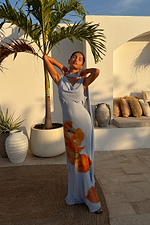 Ice Blue Floral Sophie Dress featuring a draped neckline and orange flower print, styled with a multi-wear scarf on vacation.